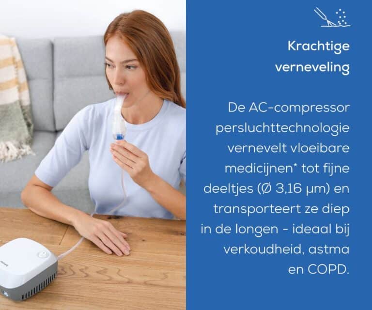 Vrouw zit aan tafel en gebruikt de Beurer IH 18 vernevelaar met het mondstuk in de mond